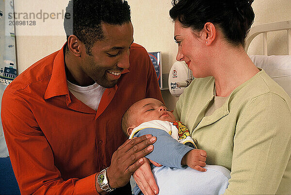 Father visiting mother and baby patients in hospital.