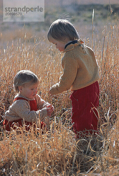 Lifestyle. Children. Boy & girl outdoors in countryside.