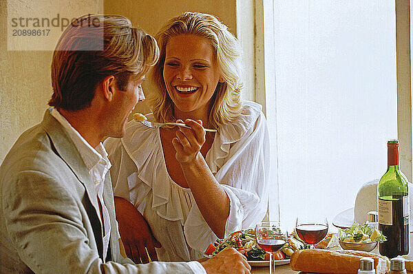 Indoor close up of young couple dining.