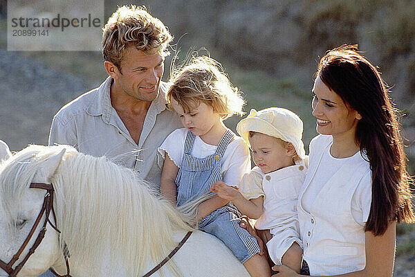 Family outdoors. Children's pony ride.