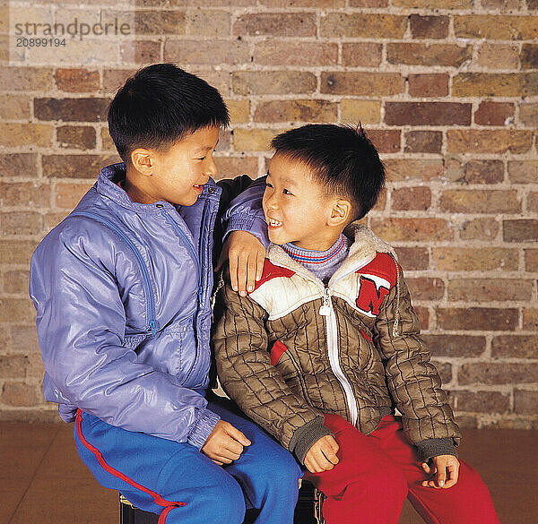 Children. Two boys sitting together.