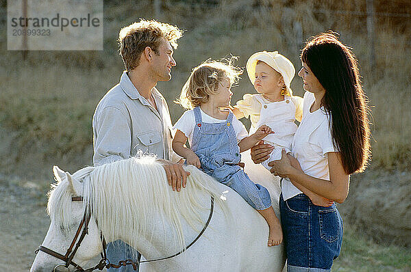 Family outdoors. Children's pony ride.