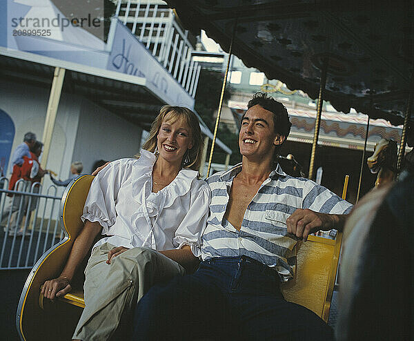 Australia. Sydney. Luna Park. Young couple at funfair.