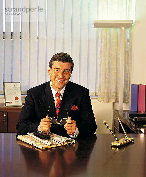 Front view of businessman sitting at his desk.