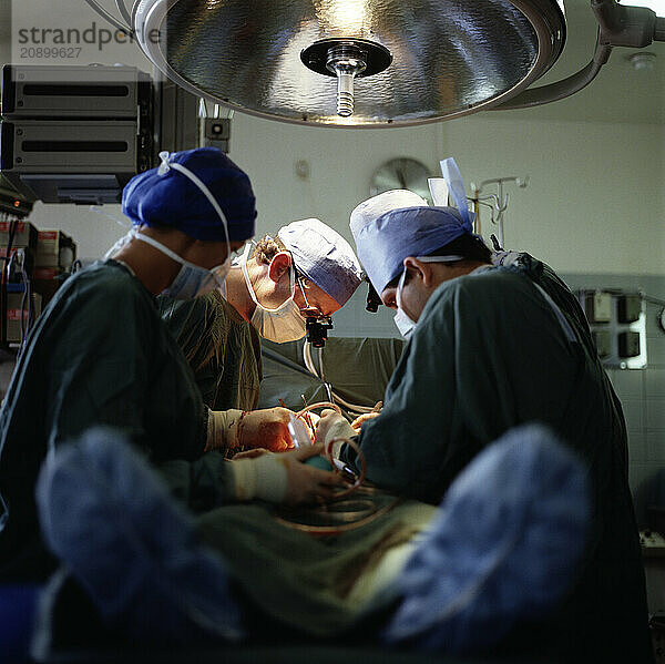 Medicine. Surgical team operating on patient.