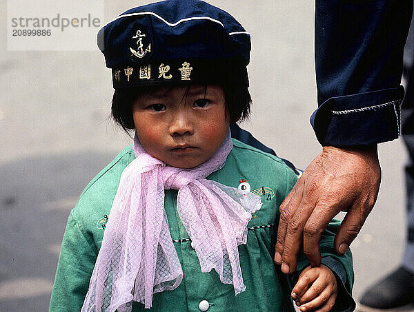 China. Shanghai. Urban close up of little girl holding father's hand.