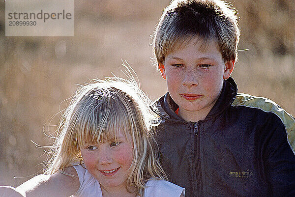 Outdoor close up of boy & girl children.