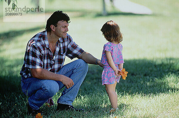 Family. Father & little daughter outdoors in the park.