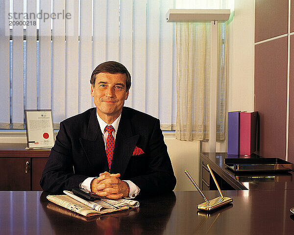 Front view of businessman sitting at his desk.