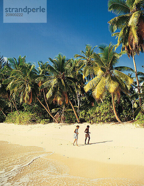 Seychelles. Mahe. Local children on Takamaka beach.