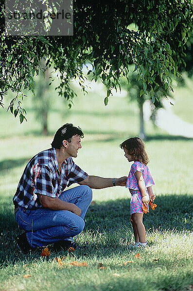 Family. Father & little daughter outdoors in the park.