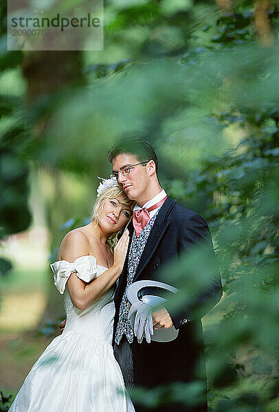 Lifestyle. Wedding couple. Bride and groom outdoors in garden.