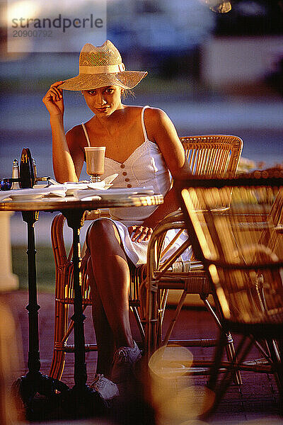 Young woman sitting in outdoor café.