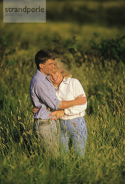 Young romantic couple outdoors in countryside.