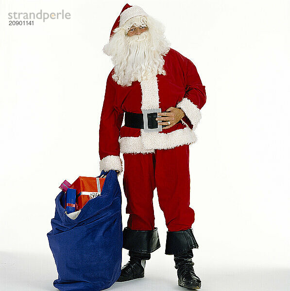 Christmas. Santa Claus standing with sack of presents.