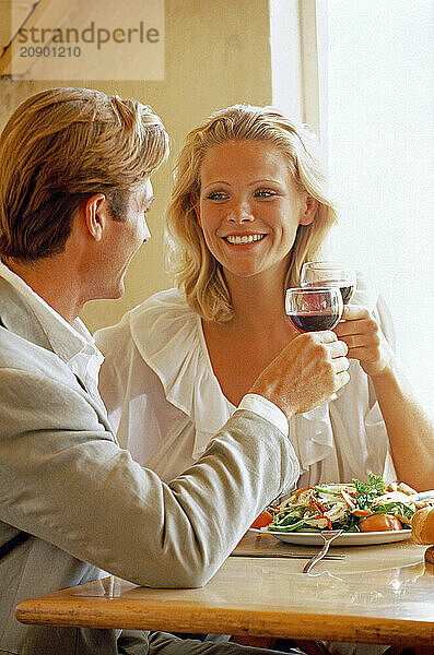 Close up of young couple dining indoors.