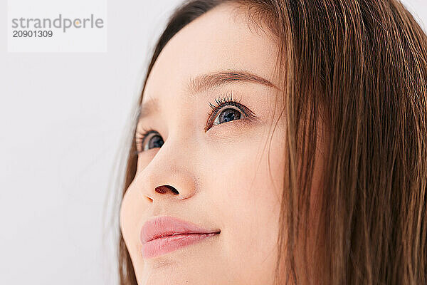 Asian Woman With Long Brown Hair Looking Up