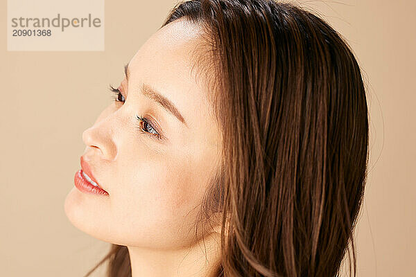 Asian Woman With Long Brown Hair Looking Up