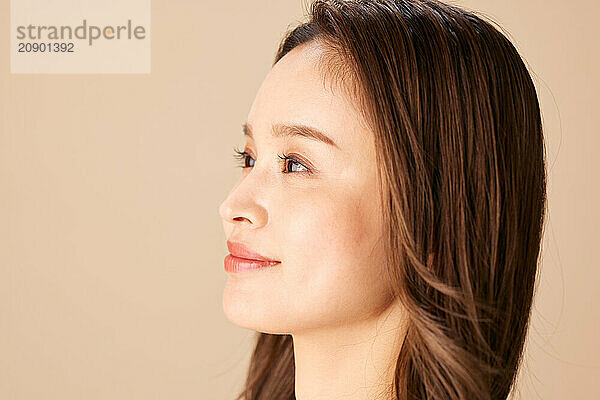 Asian Woman With Long Brown Hair Looking Up