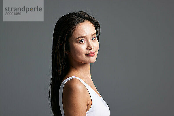 A Beautiful Young Woman In A White Tank Top