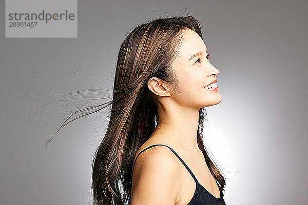 Asian Woman With Long Hair And A Smile