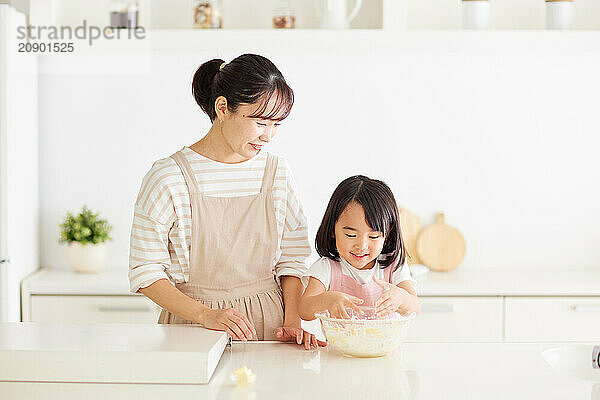 Japanese mother and daughter cooking in the kitchen