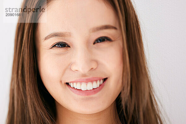 Asian Woman With Long Brown Hair Smiling