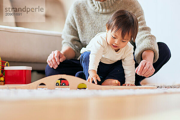 Asian child playing with wooden toys