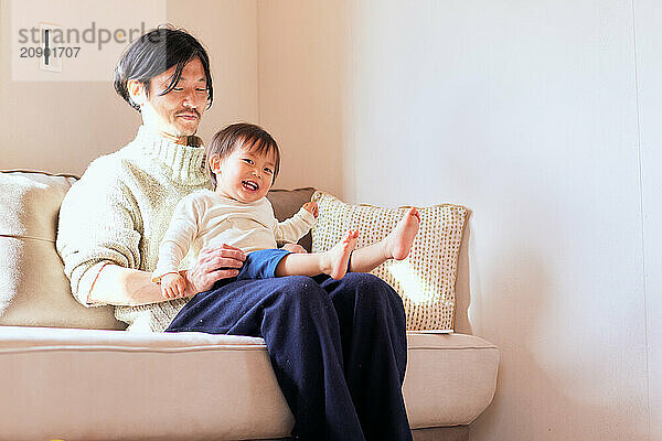 Japanese father and son on the sofa