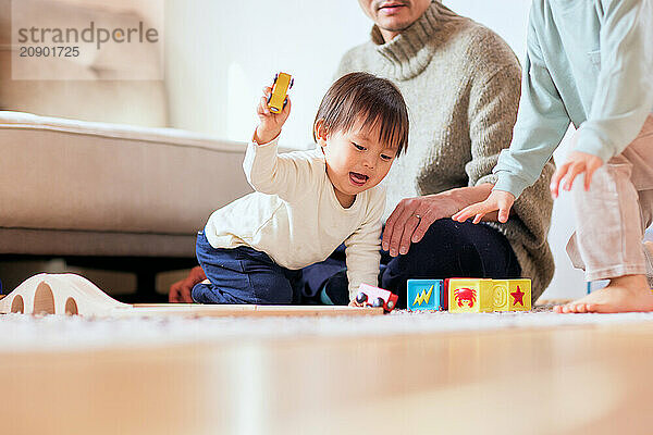 Asian child playing with wooden toys