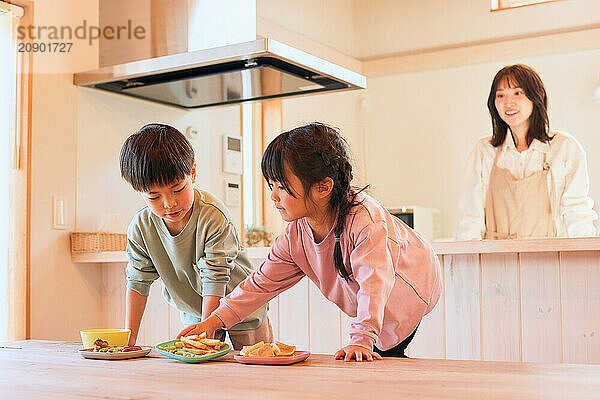 Happy Japanese kids eating in the dining room