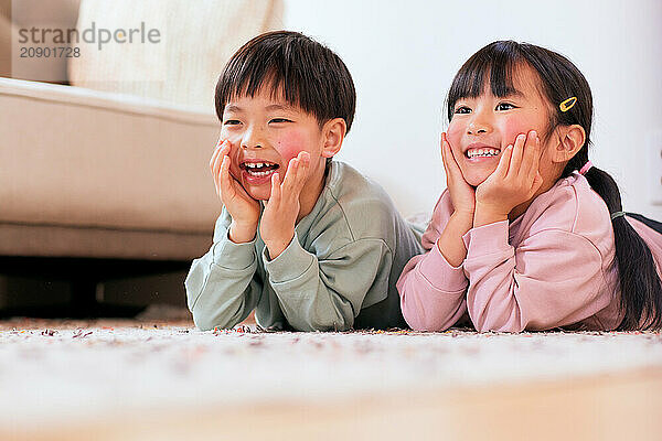 Happy Japanese kids playing on the floor