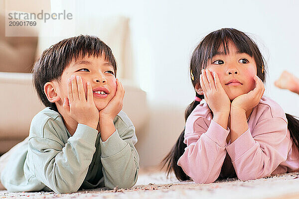 Happy Japanese kids playing on the floor