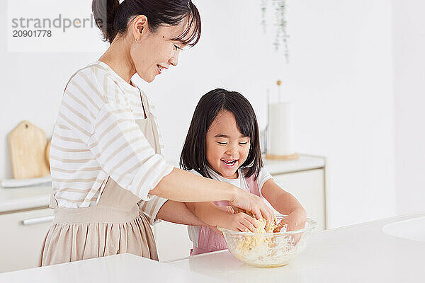 Japanese mother and daughter cooking in the kitchen