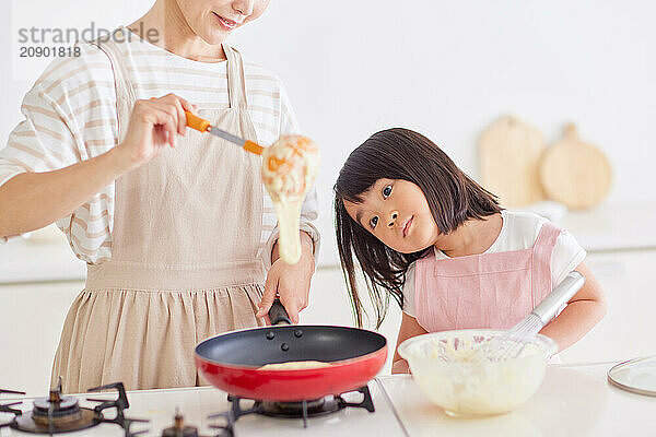 Japanese mother and daughter cooking in the kitchen