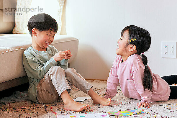 Happy Japanese kids playing on the floor