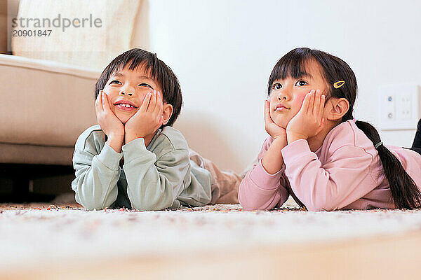 Happy Japanese kids playing on the floor