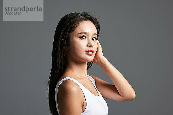 Beautiful Asian Woman Posing With Her Hand On Her Head