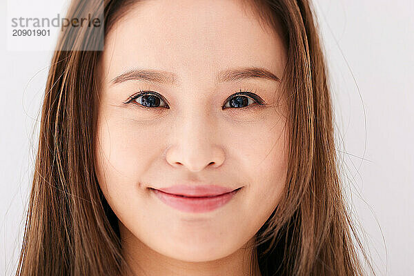 Asian Woman With Long Brown Hair And A Smile