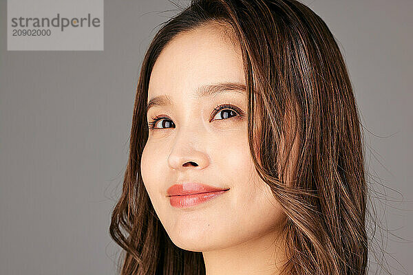 Asian Woman With Long Brown Hair And A Smile