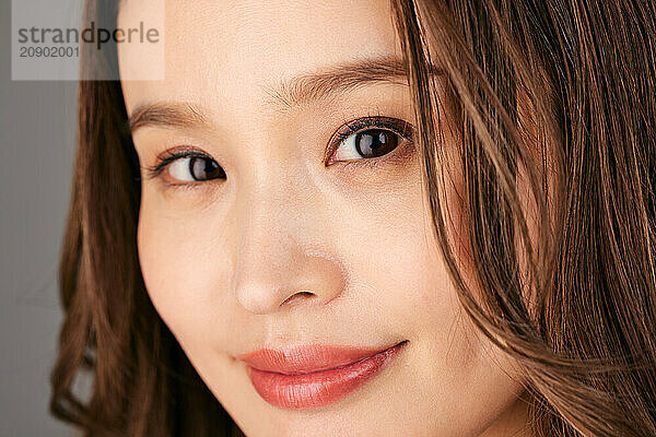 Asian Woman With Long Brown Hair And A Smile