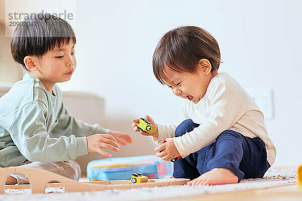 Happy Japanese kids playing on the floor