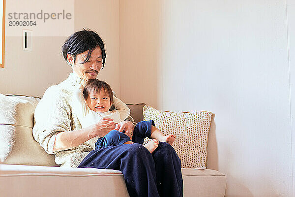 Japanese father and son on the sofa