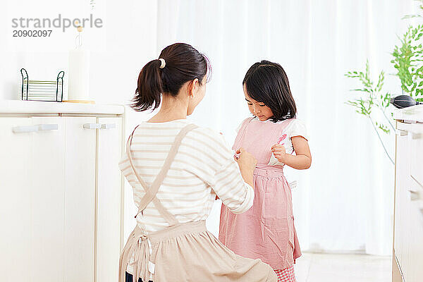 Asian woman and girl in the kitchen