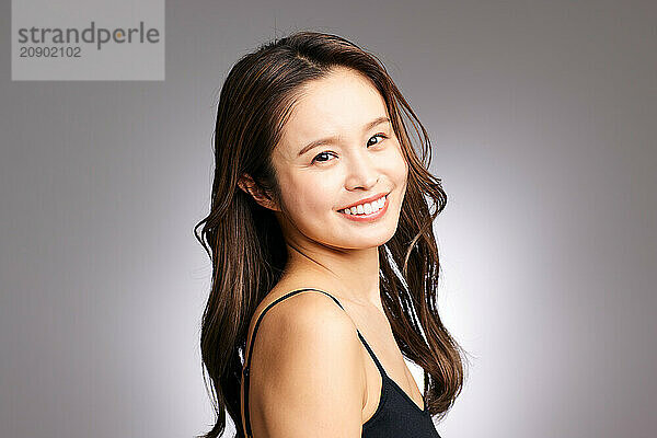 Asian Woman In A Black Top Smiling