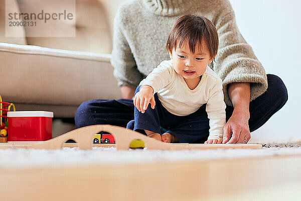 Asian child playing with wooden toys