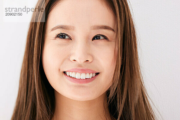 Asian Woman With Long Brown Hair Smiling