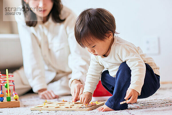 Asian child playing with wooden toys