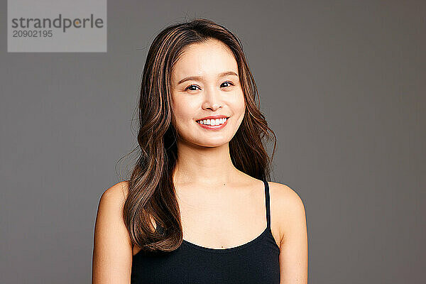 Asian Woman In A Black Tank Top Smiling