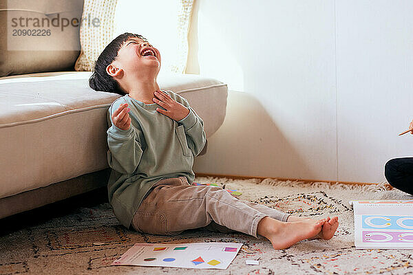 Asian kid sitting on the floor